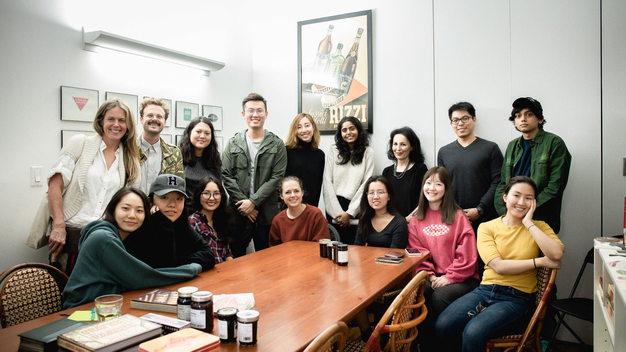 students pose with Louise Fili in her studio