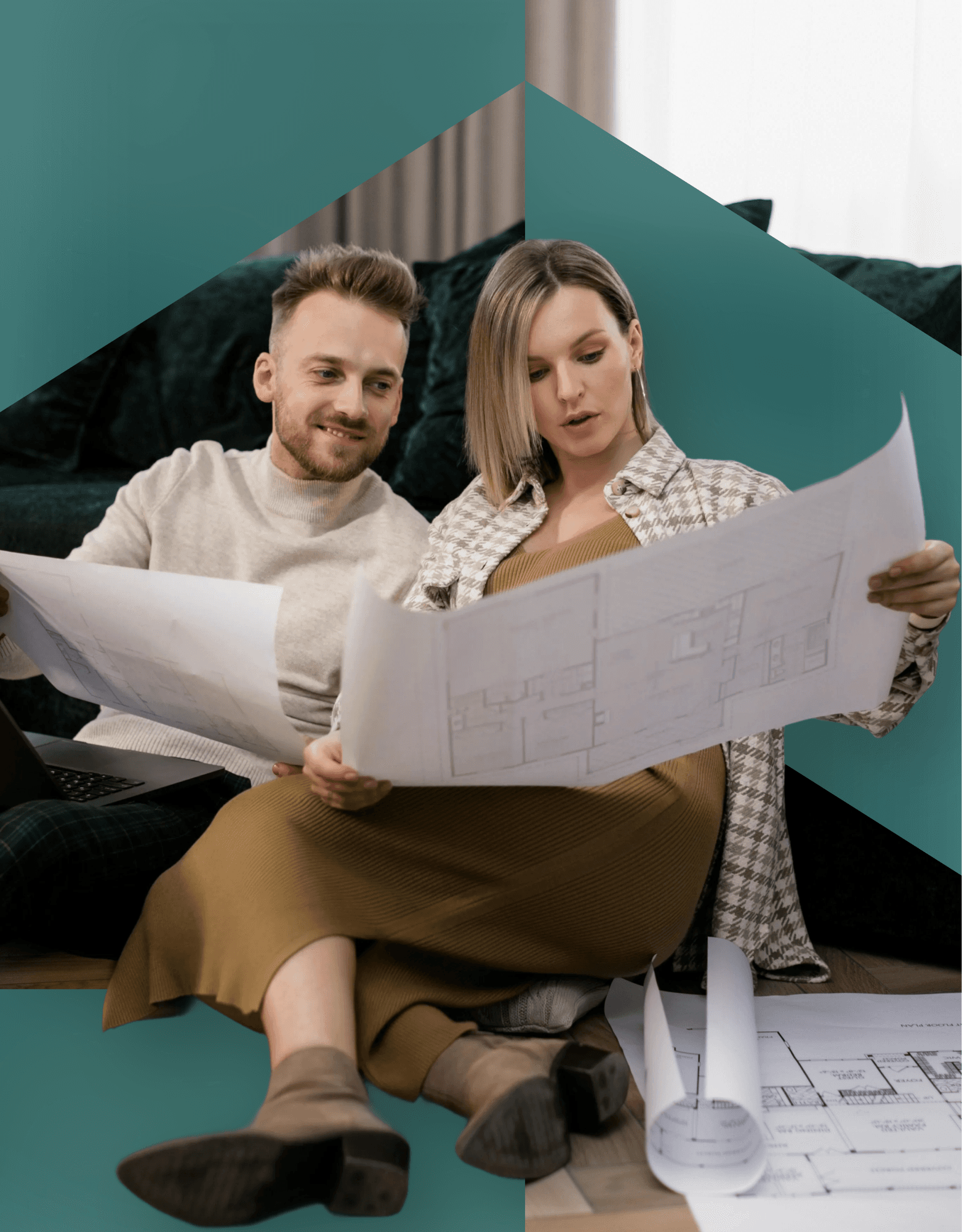 A couple sitting on the floor, smiling, while reading a large paper together in a cozy, modern space.