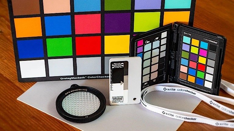 Color calibration charts and photography tools on a table.