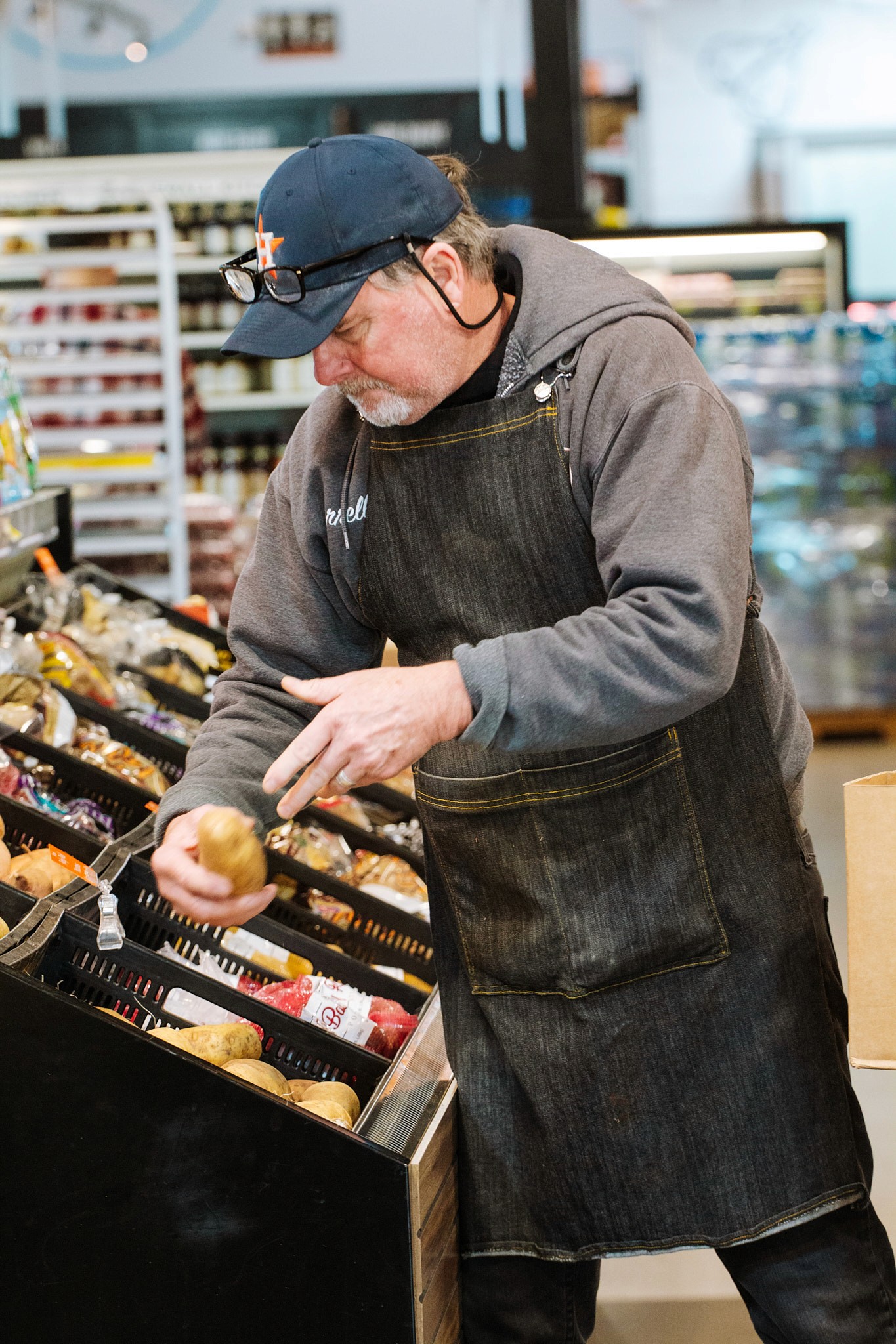 man working in local supermarket