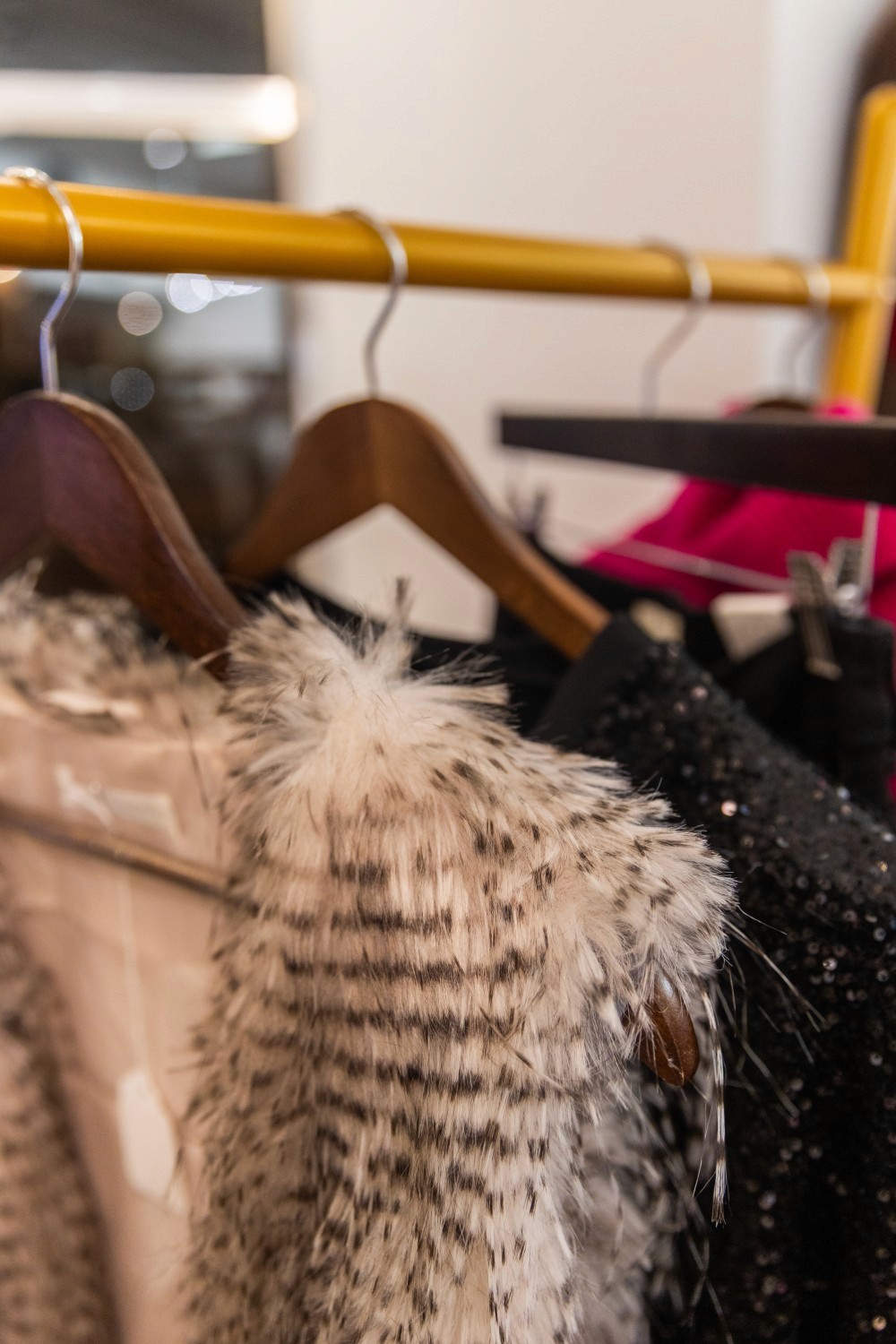 Close up shot of clothes on hangers.