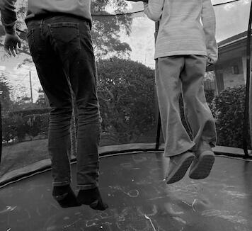 children bouncing on trampoline