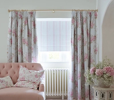 Room with layered blackout curtains and dim-out roman blind