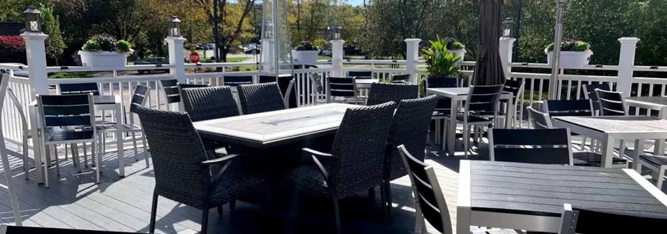 Restaurant patio with various tables and chairs.