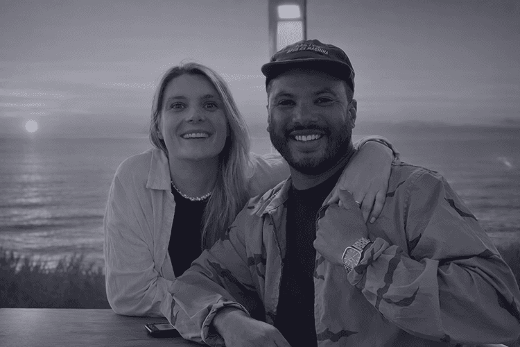 Couple portrait with dog on field