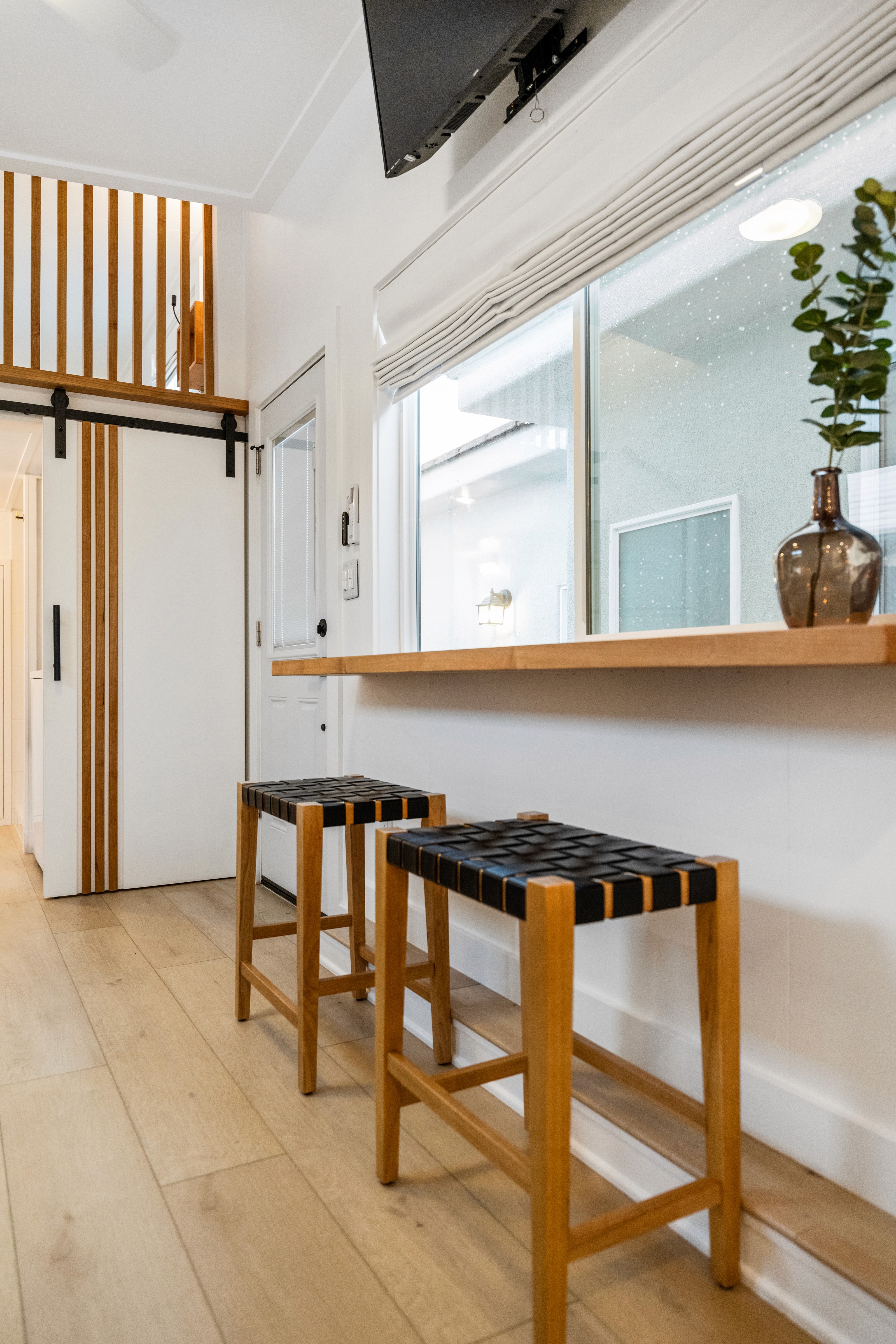 St. George Utah home kitchen highlighting green cabinetry, natural wood island, and retro-modern design with a natural wood custom hood.