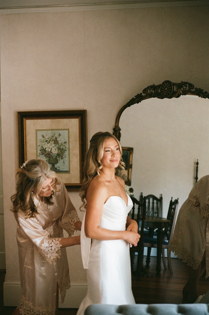     Wedding photographer South Florida captures a bride getting ready with her mother before the ceremony.