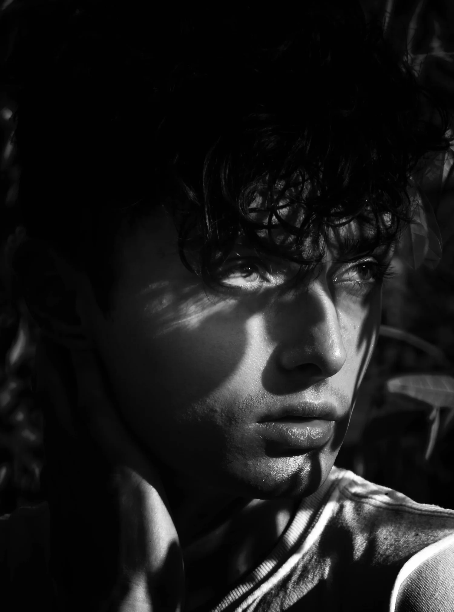 Close-up of a yellow tennis ball sitting on a green court, positioned near the white center line.