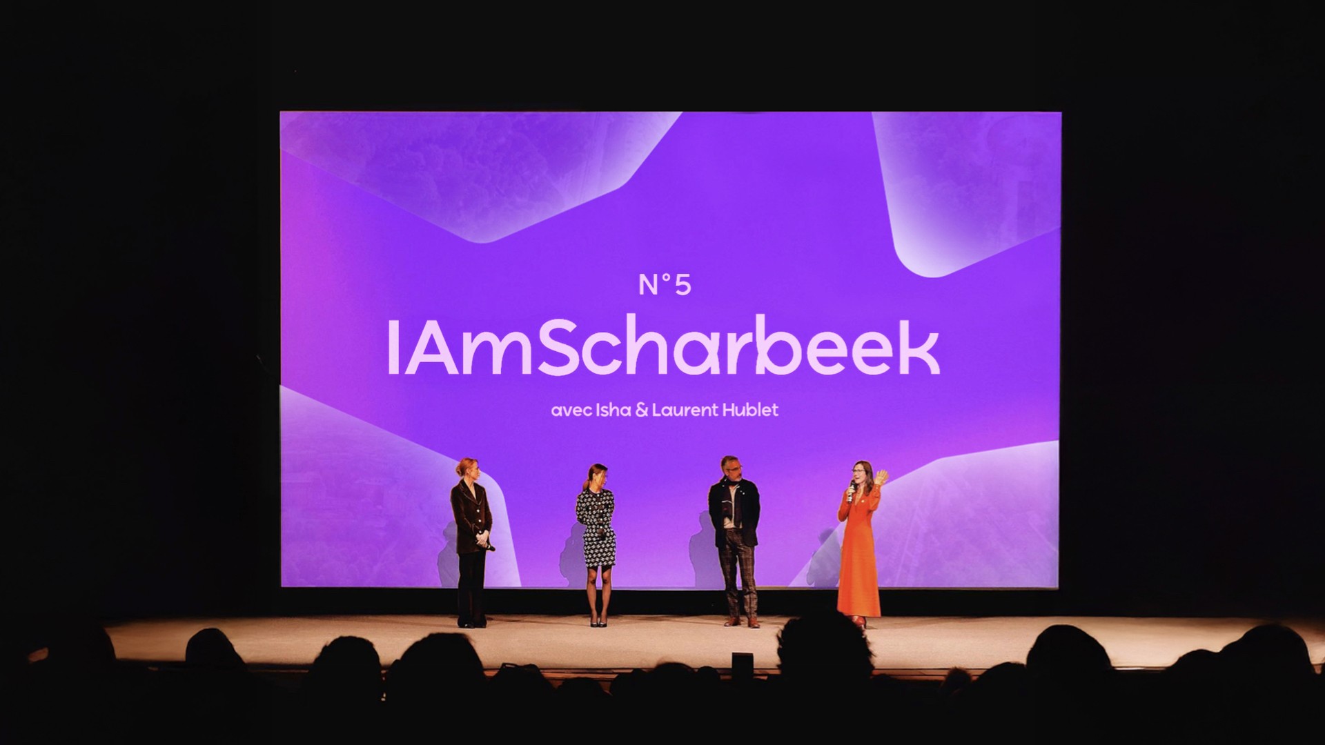Modern home office setup with a monitor, ergonomic chair, keyboard, and indoor plants near a window with blinds.
