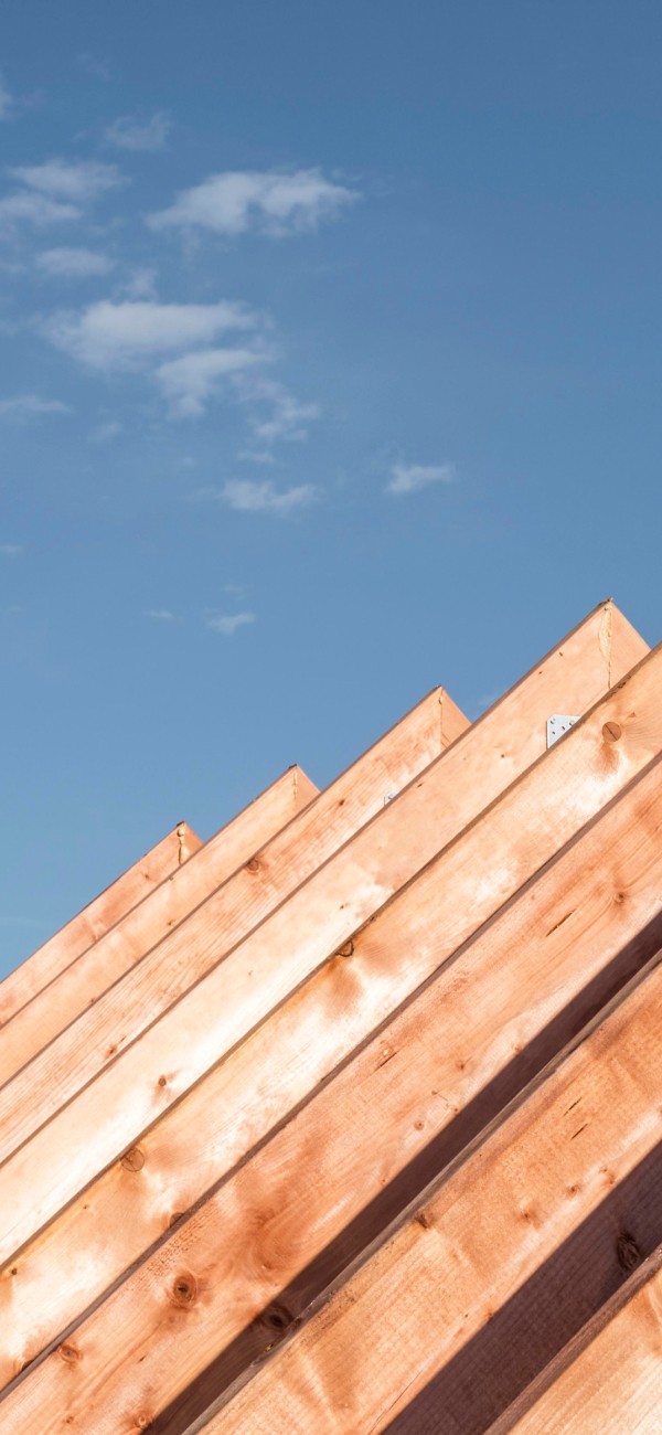 wooden rafter structure -support fir the roof, skyes on the background