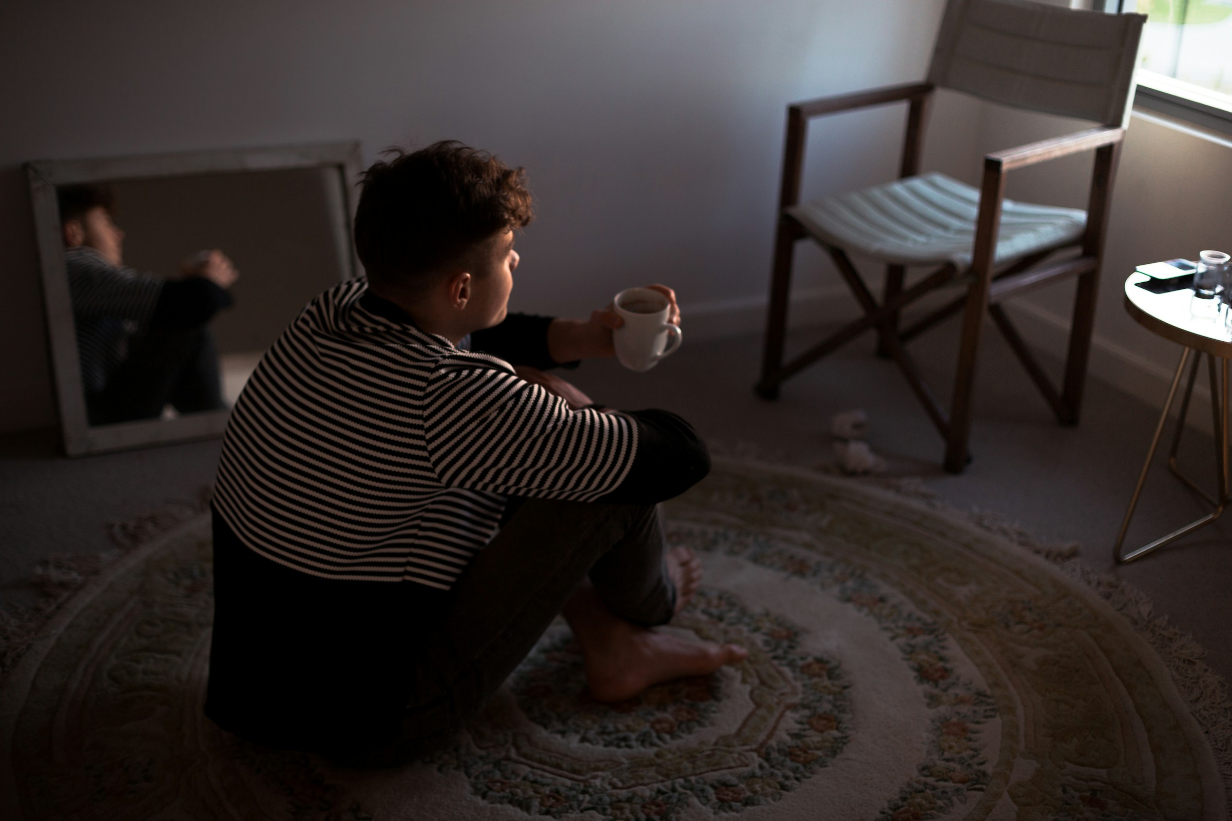 person drinking coffee - Best Sitting Posture on Floor