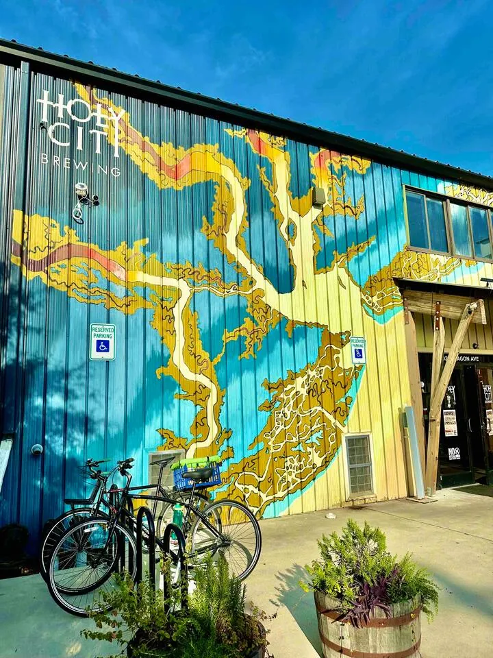 Painted mural at Holy City Brewing with bikes parked below