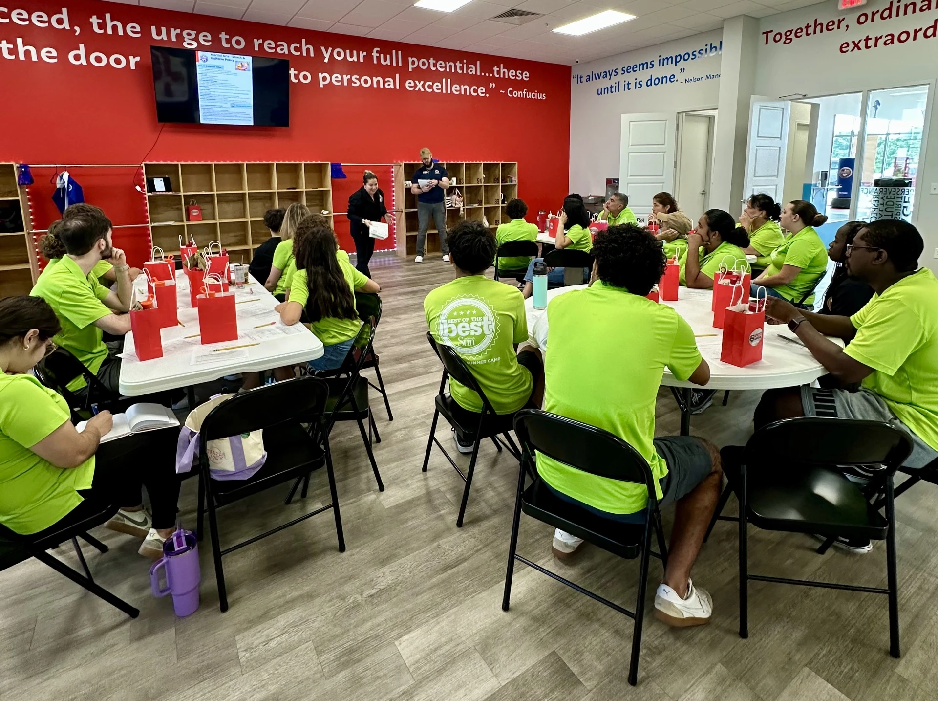 Team members holding a donation cheque in front of Okito Alachua location