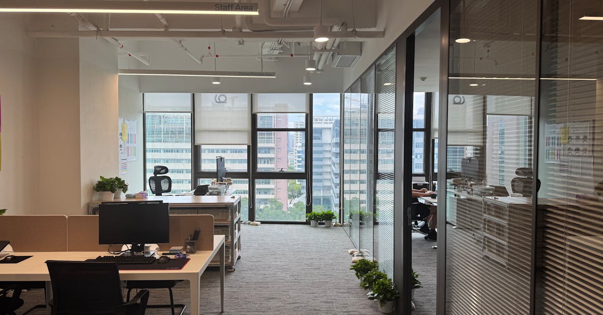 Bright, modern office interior with large windows and open workspace design.