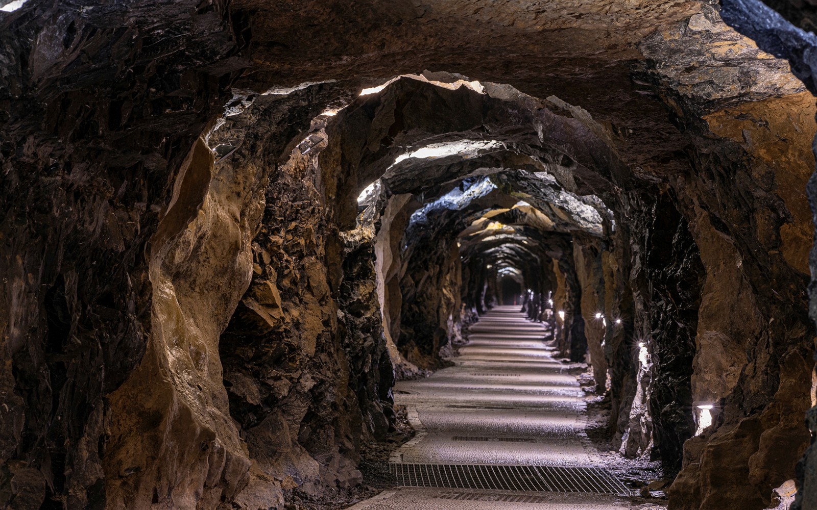 Aillwee Caves tunnel with illuminated rocky walls and pathway.