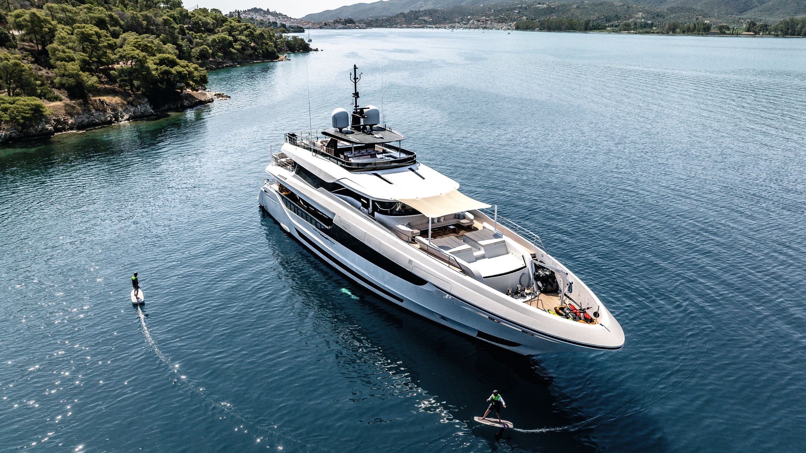 A large motor yacht anchored in calm Mediterranean waters, illustrating private yacht ownership and operational considerations.
