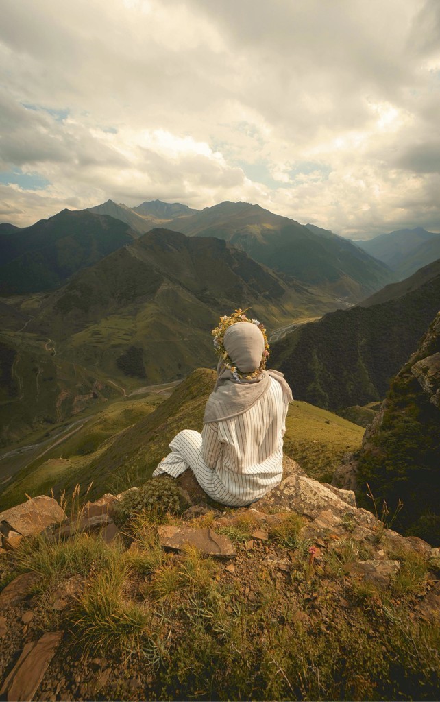 Muslim hijabi girls sitting and reflecting on a mountain top in nature