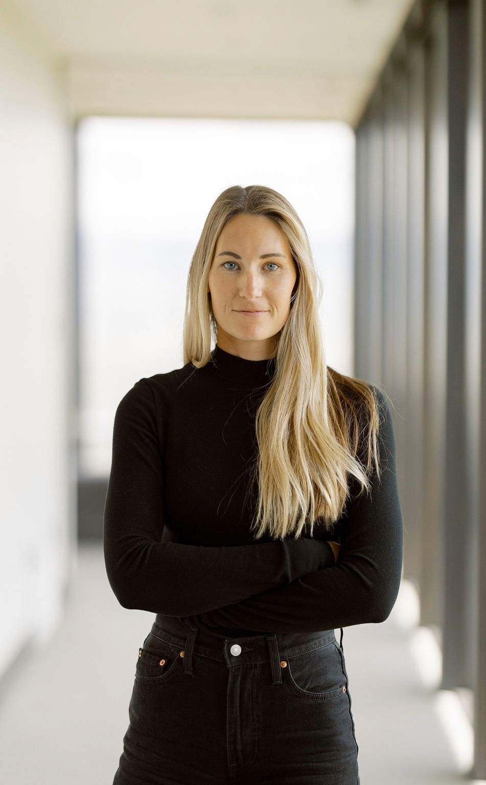 Portrait of a person in dark clothing speaking on a phone