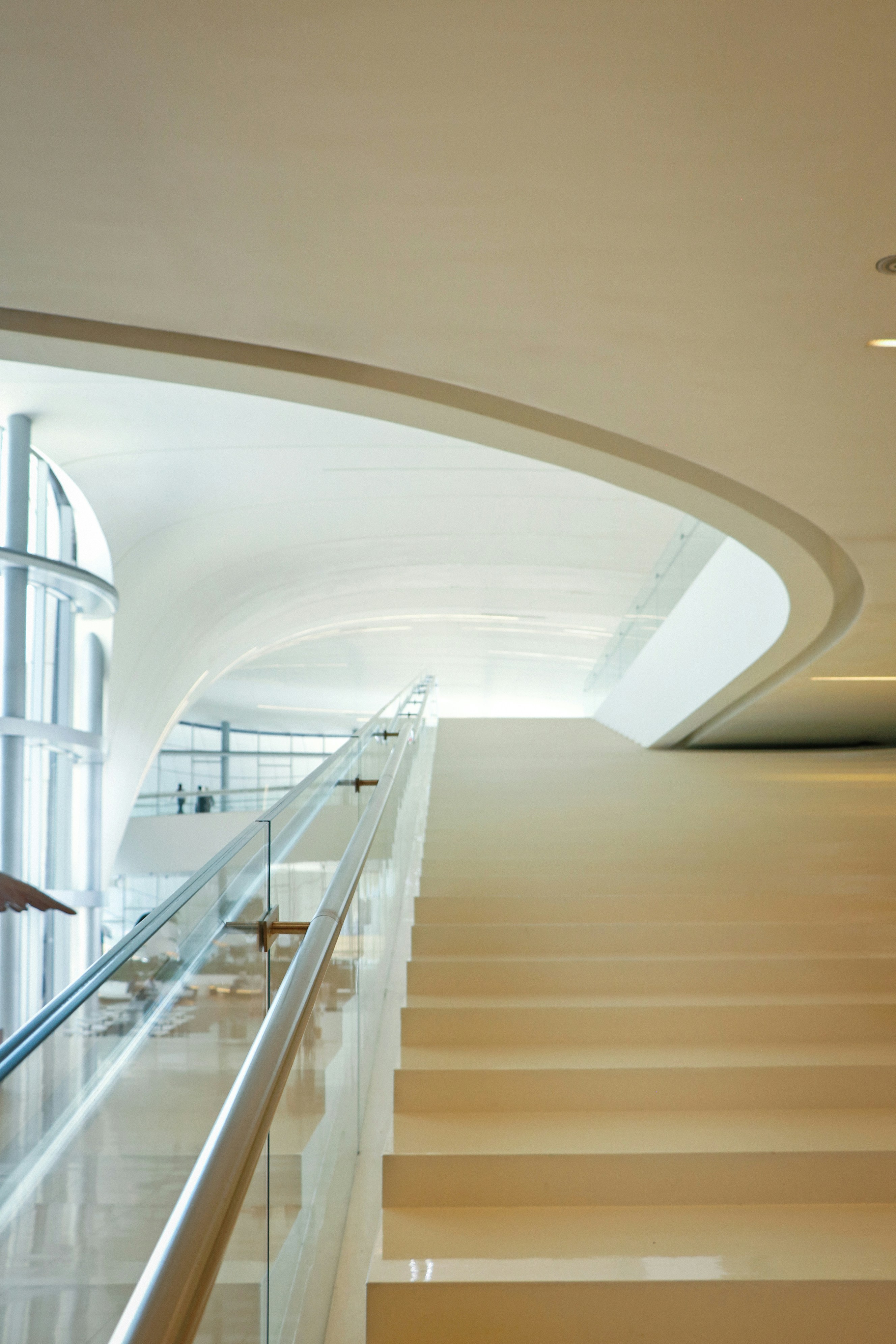 Modern stairs lead up into a bright hallway.