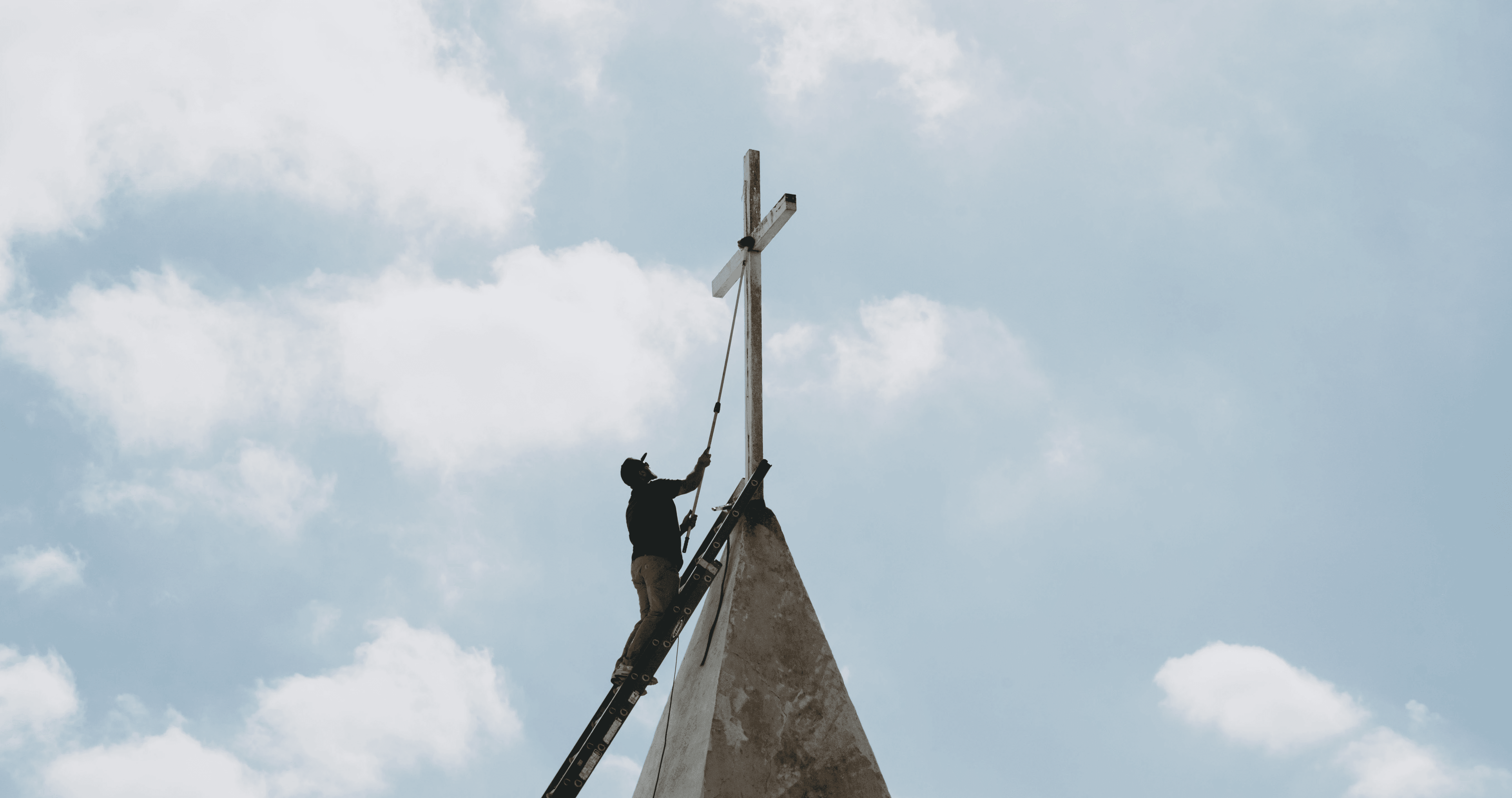 person sitting on grass and using phone