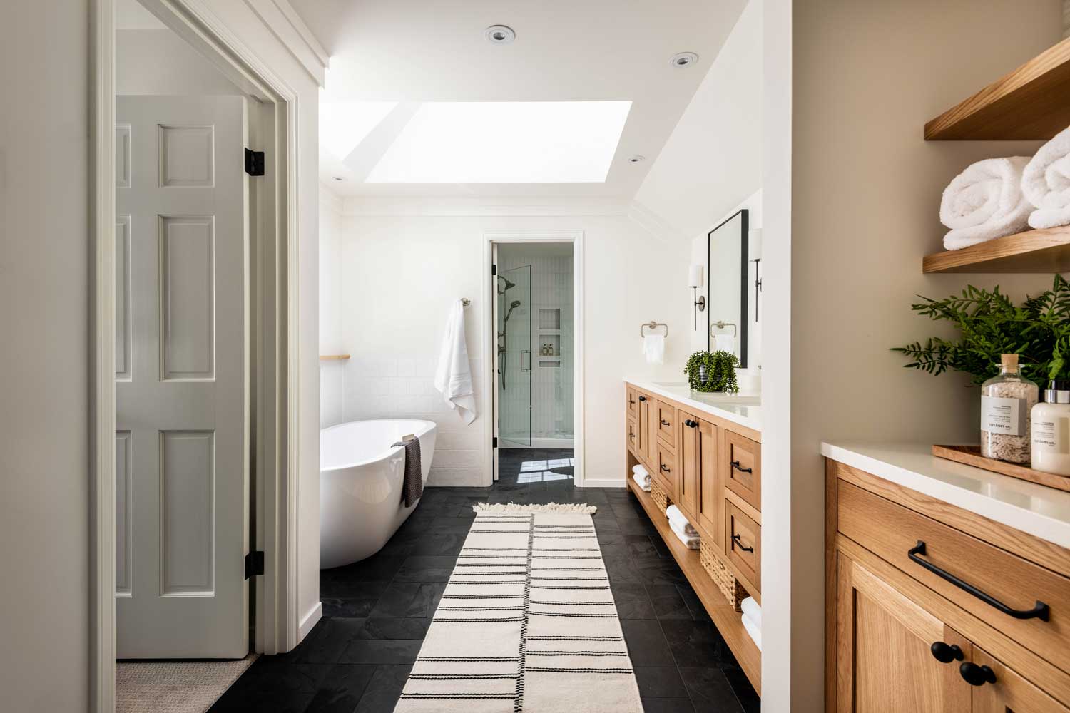 Redmond WA remodeled bathroom pulling inspiration from nature.  Stand alone bathtub and skylight create a modern bathroom.  Full service interior design firm Elegant Simplicity carries out this design.