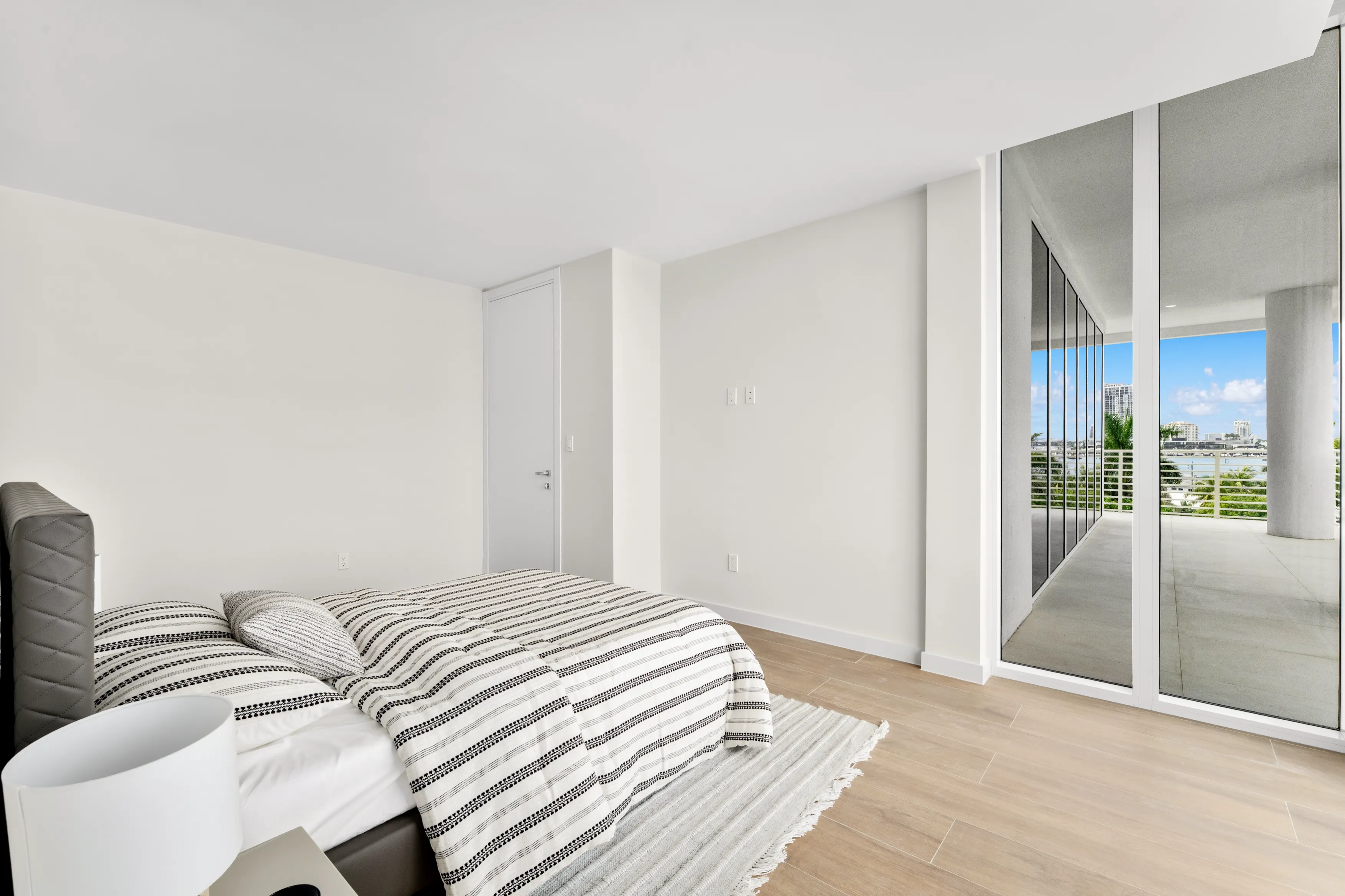 Modern bedroom featuring wood paneling and white walls, creating a clean and contemporary aesthetic.