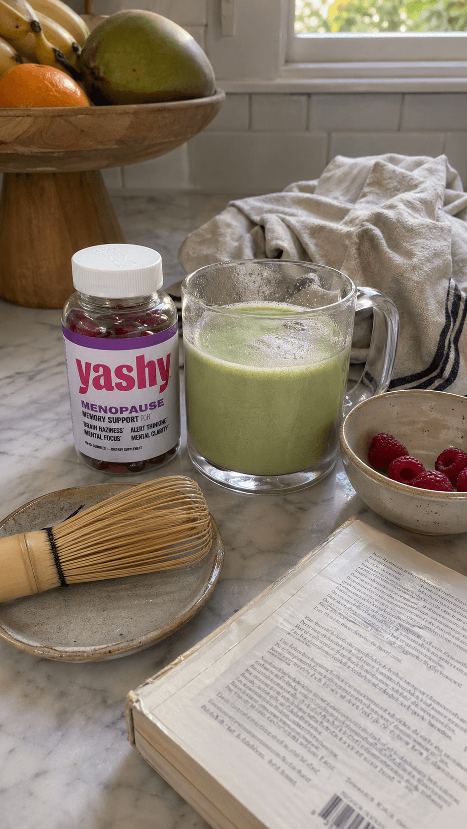 Yashy gummies styled on a marble counter with a matcha latte and raspberries