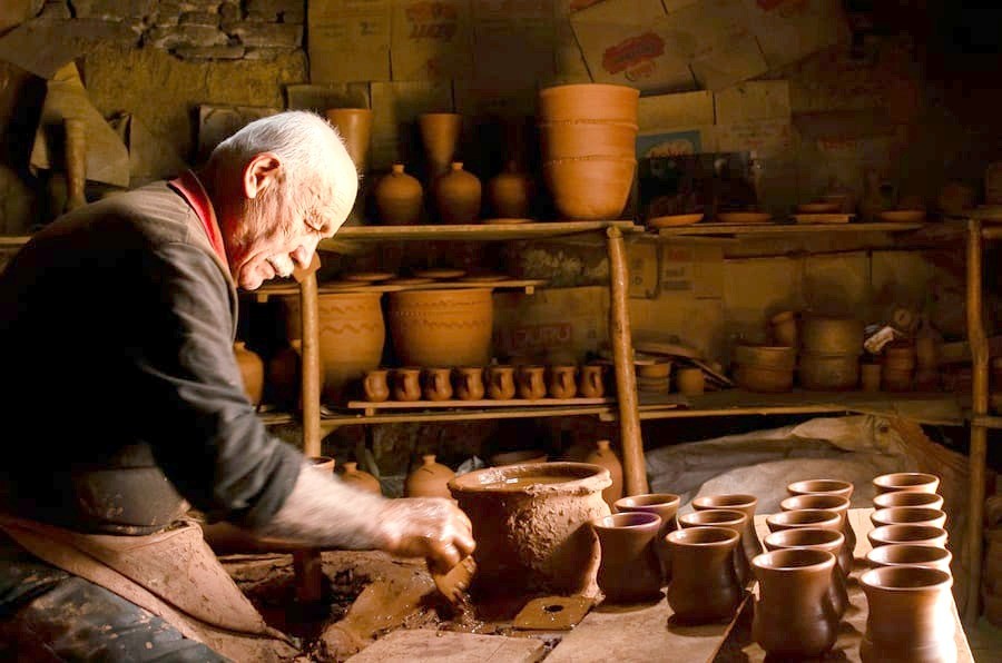 Potter shaping clay in a workshop