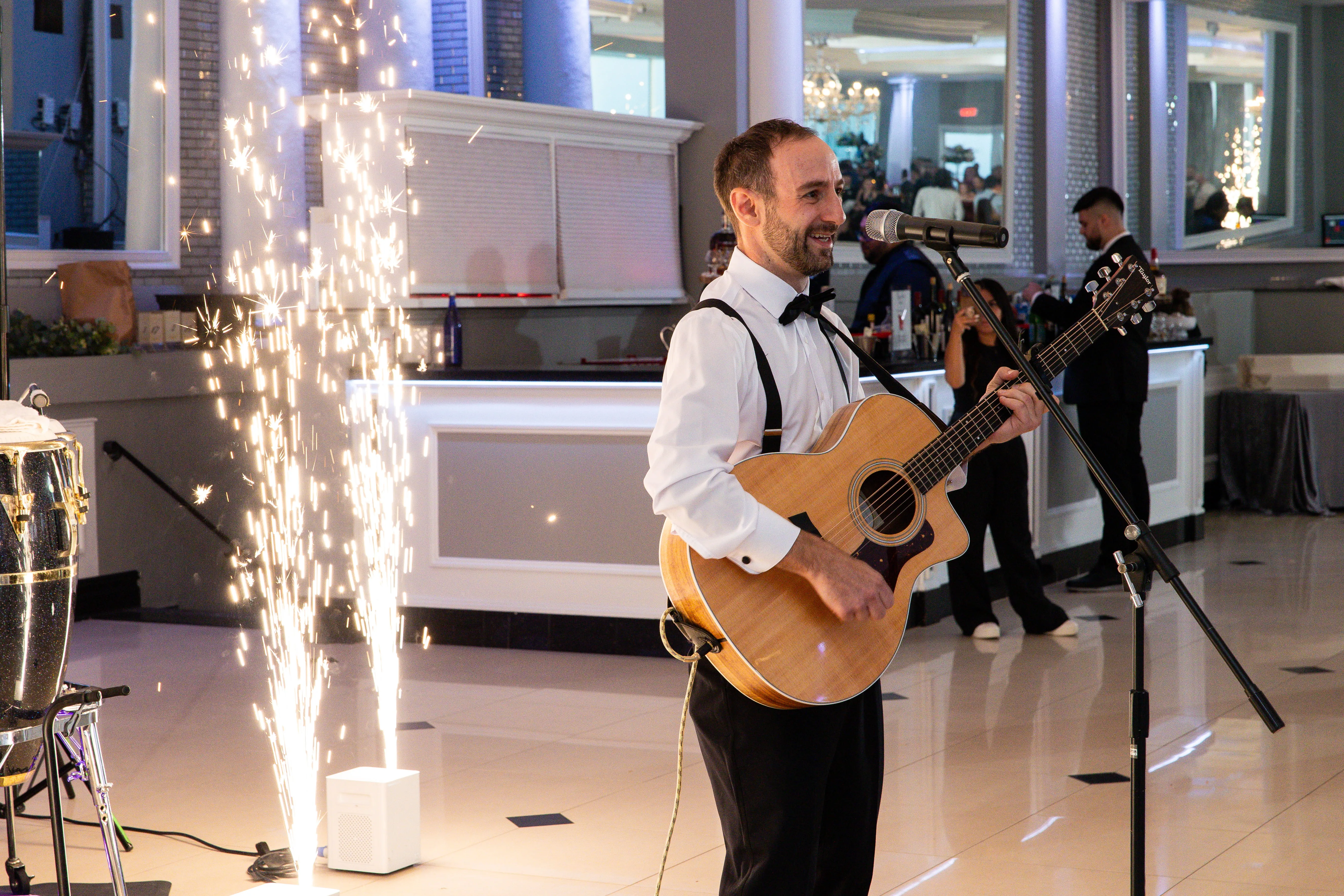 Wedding DJ with live musician and special effects creating hybrid entertainment experience