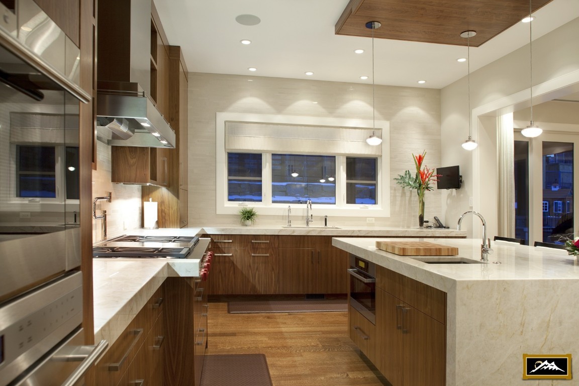Image of Luxury kitchen design with marble countertops, wood cabinets, and stainless steel appliances by KHD Homes.