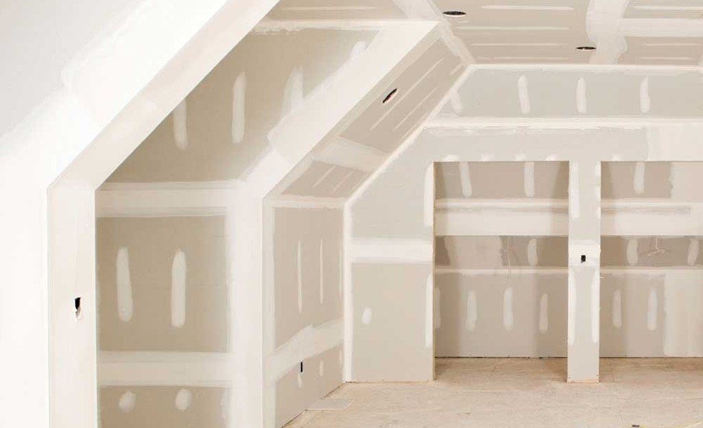 Modern bathroom featuring wooden cabinetry, a bathtub, a sleek sink, and natural light from a window.