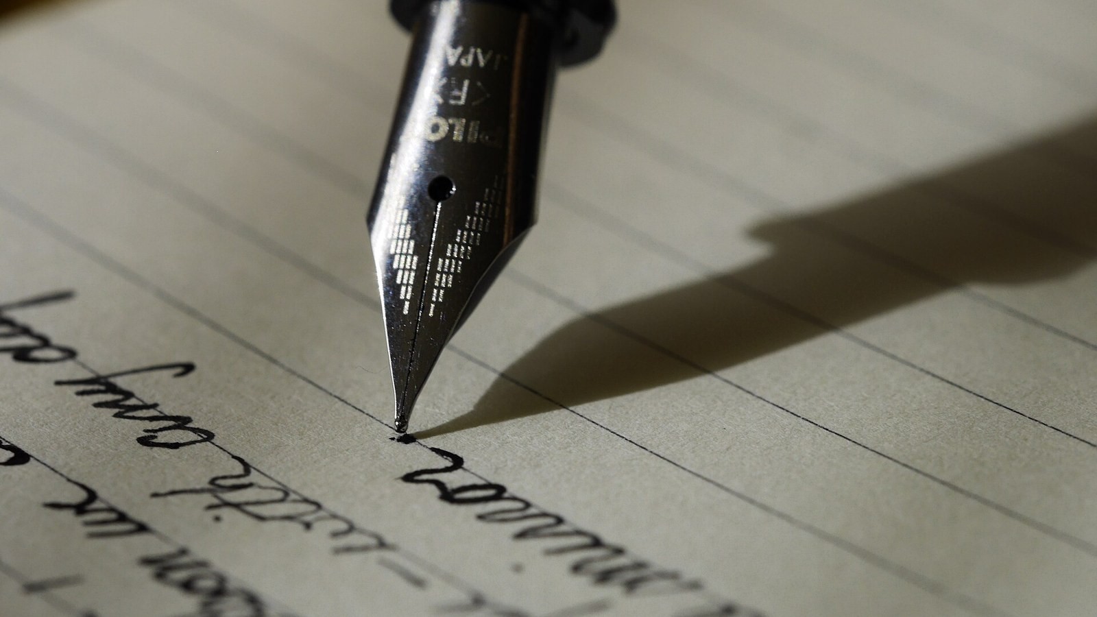 A fountain pen on lined paper.