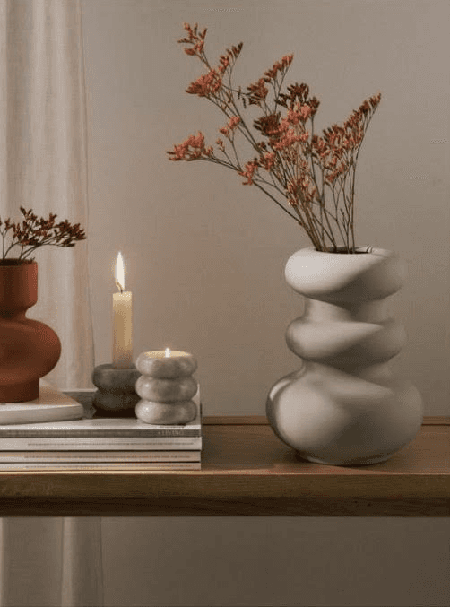 a woman sitting on a couch talking to another woman
