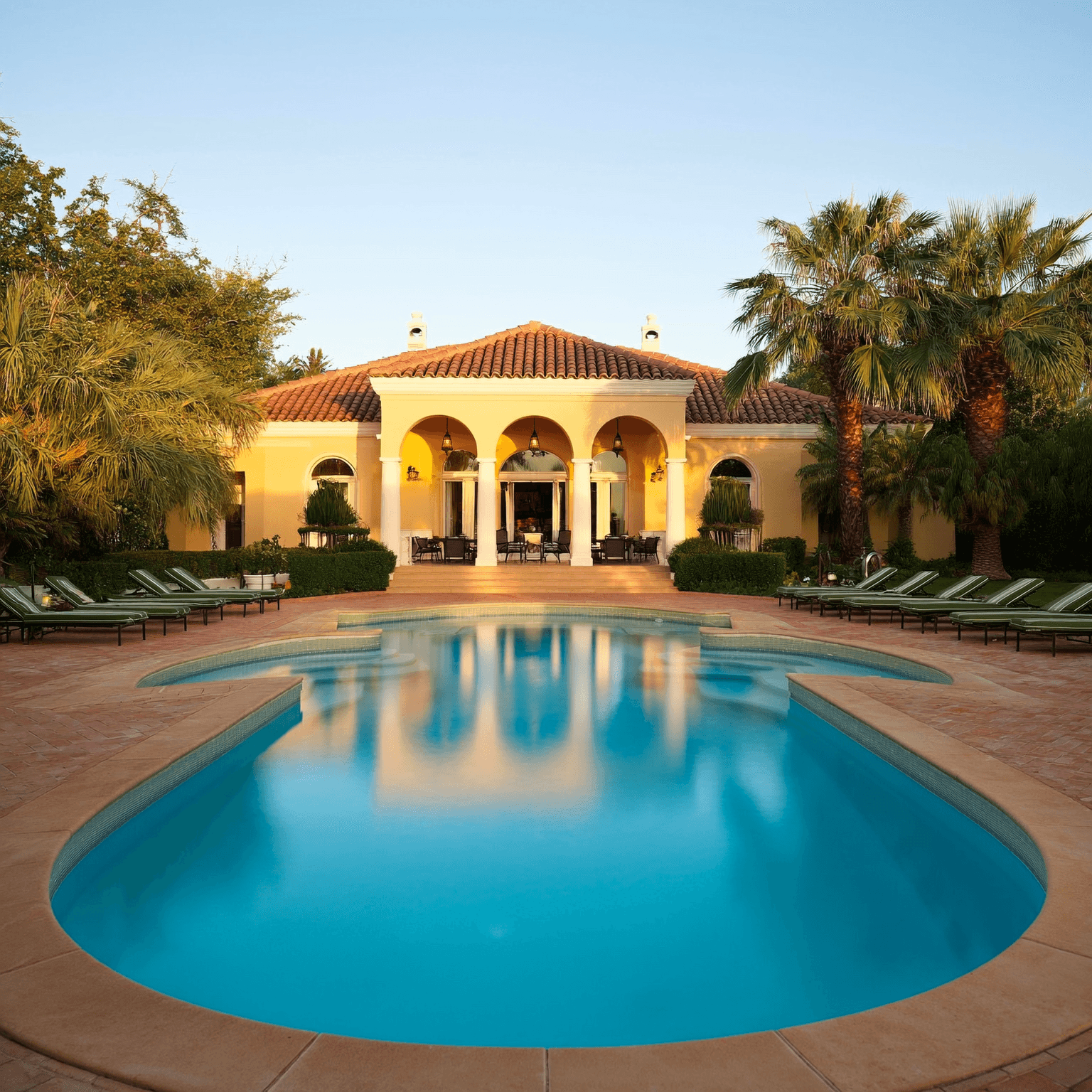 uxury residence with clean pool and palm-lined yard in Bonita Springs, Florida.