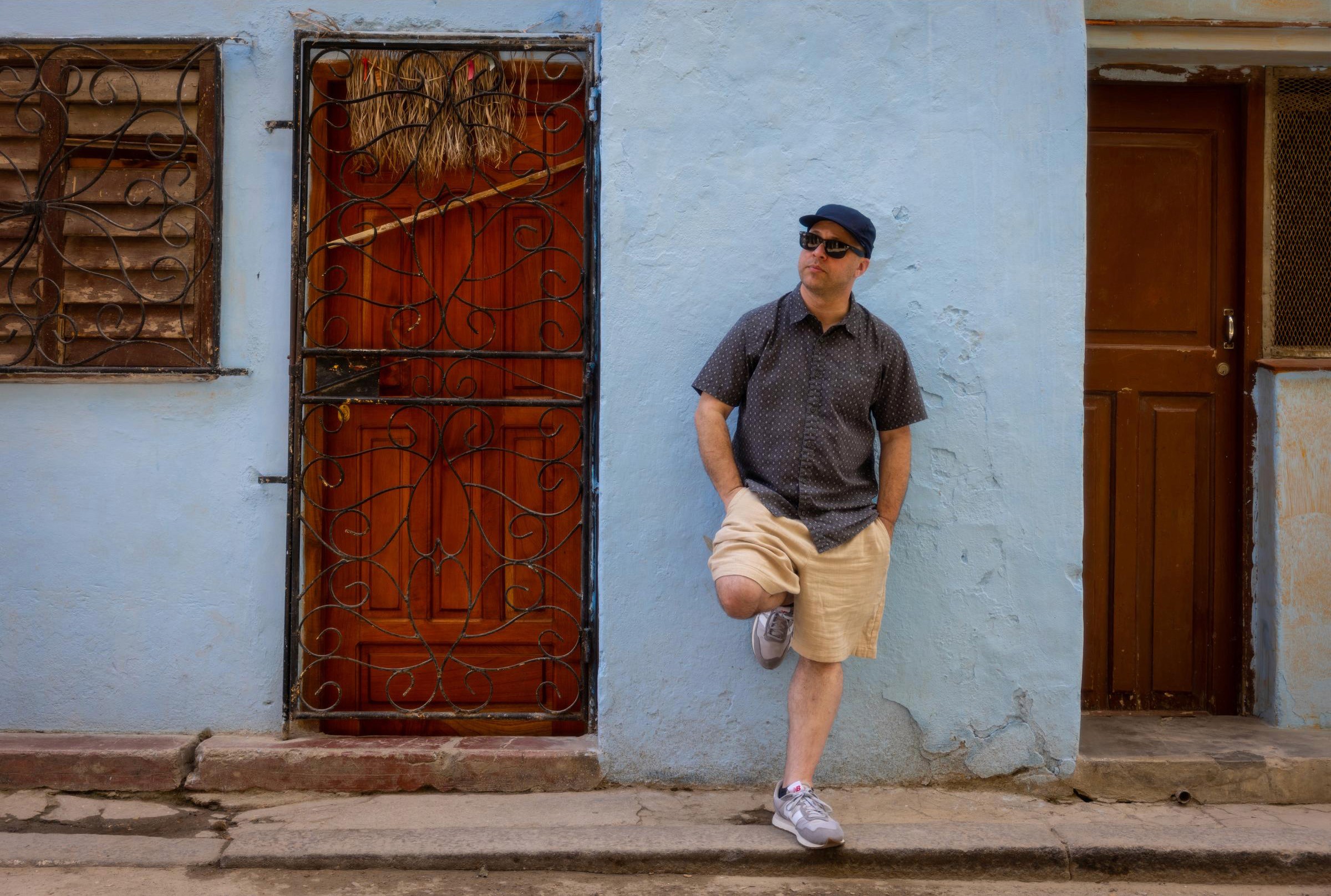 Josh takes a break near a stylish wrought iron door front.