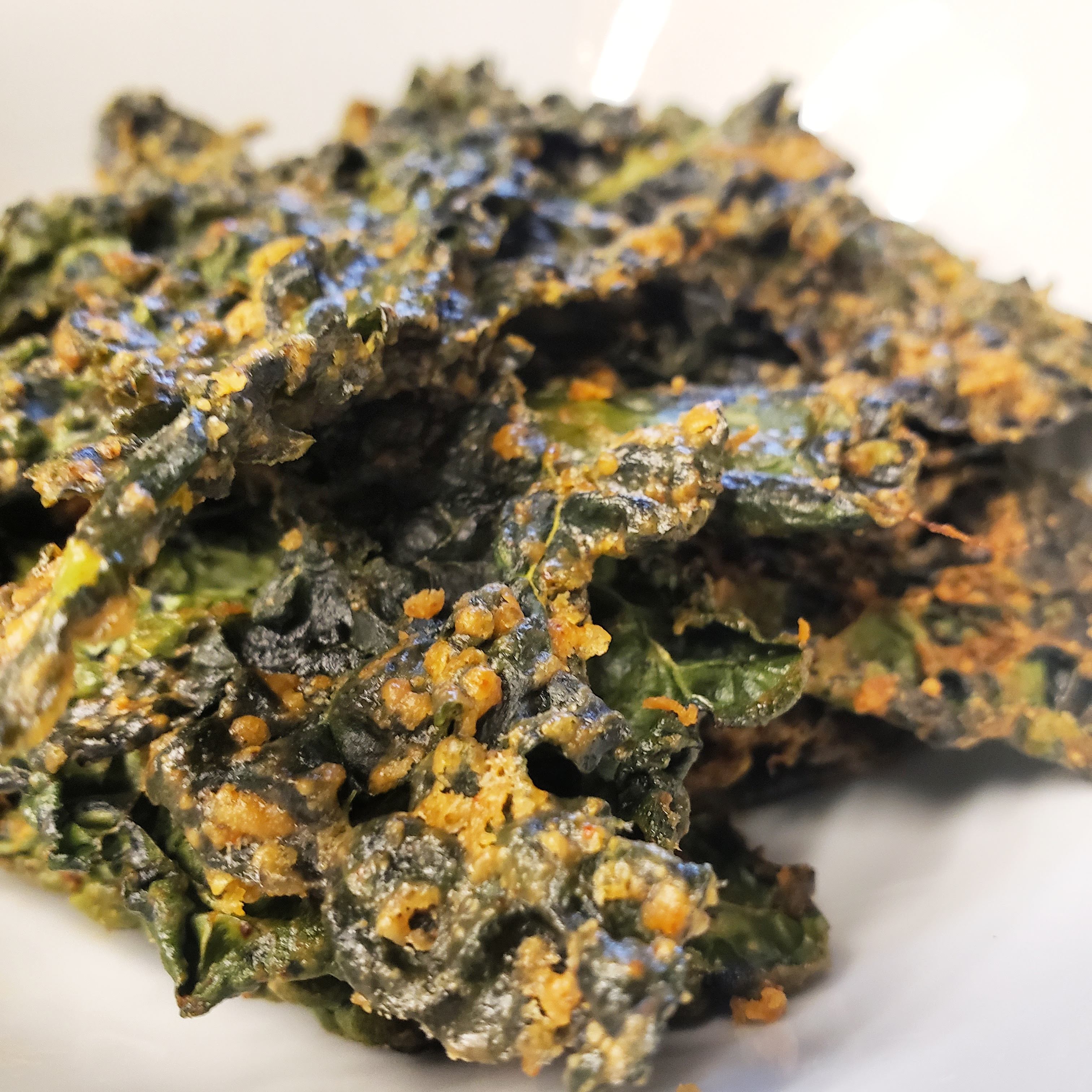 Fresh wild greens and berries in a wooden bowl, representing the hands-on results of Foraging Academy’s certification classes.
