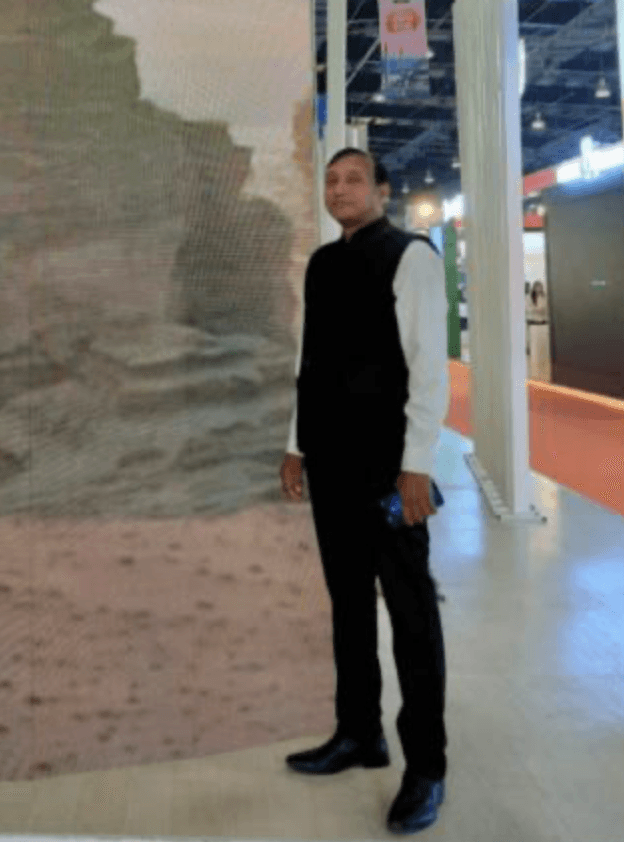 A woman with red hair is standing in the grass