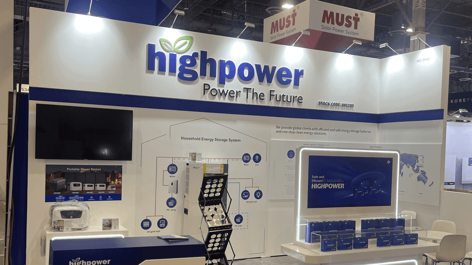 High Power RE+ 2023 10x20 booth in Las Vegas showing household energy storage system diagram, portable power station display, and front reception counter