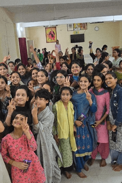 woman holding a phone and man looking at the phone. both are smiling