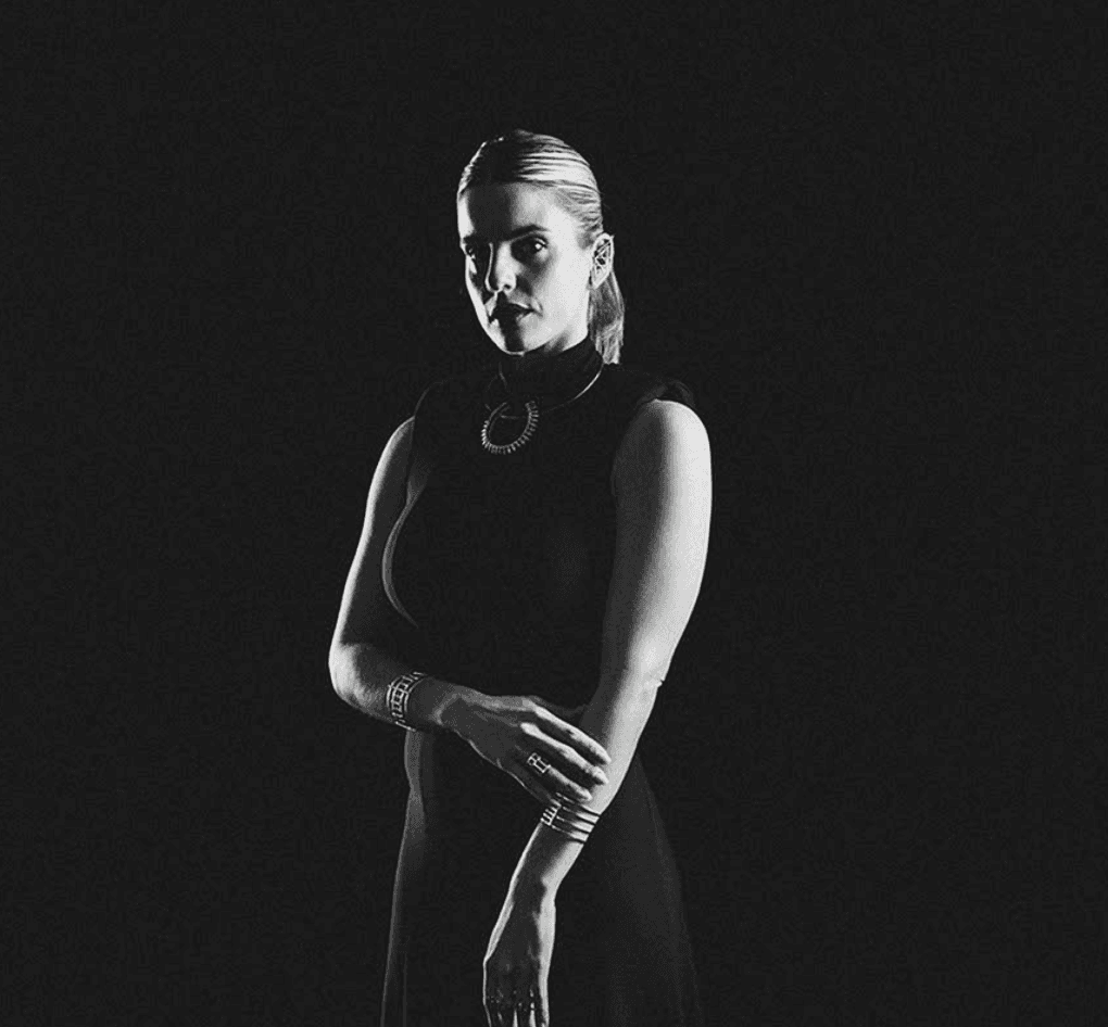 woman in black long sleeve shirt sitting on white couch