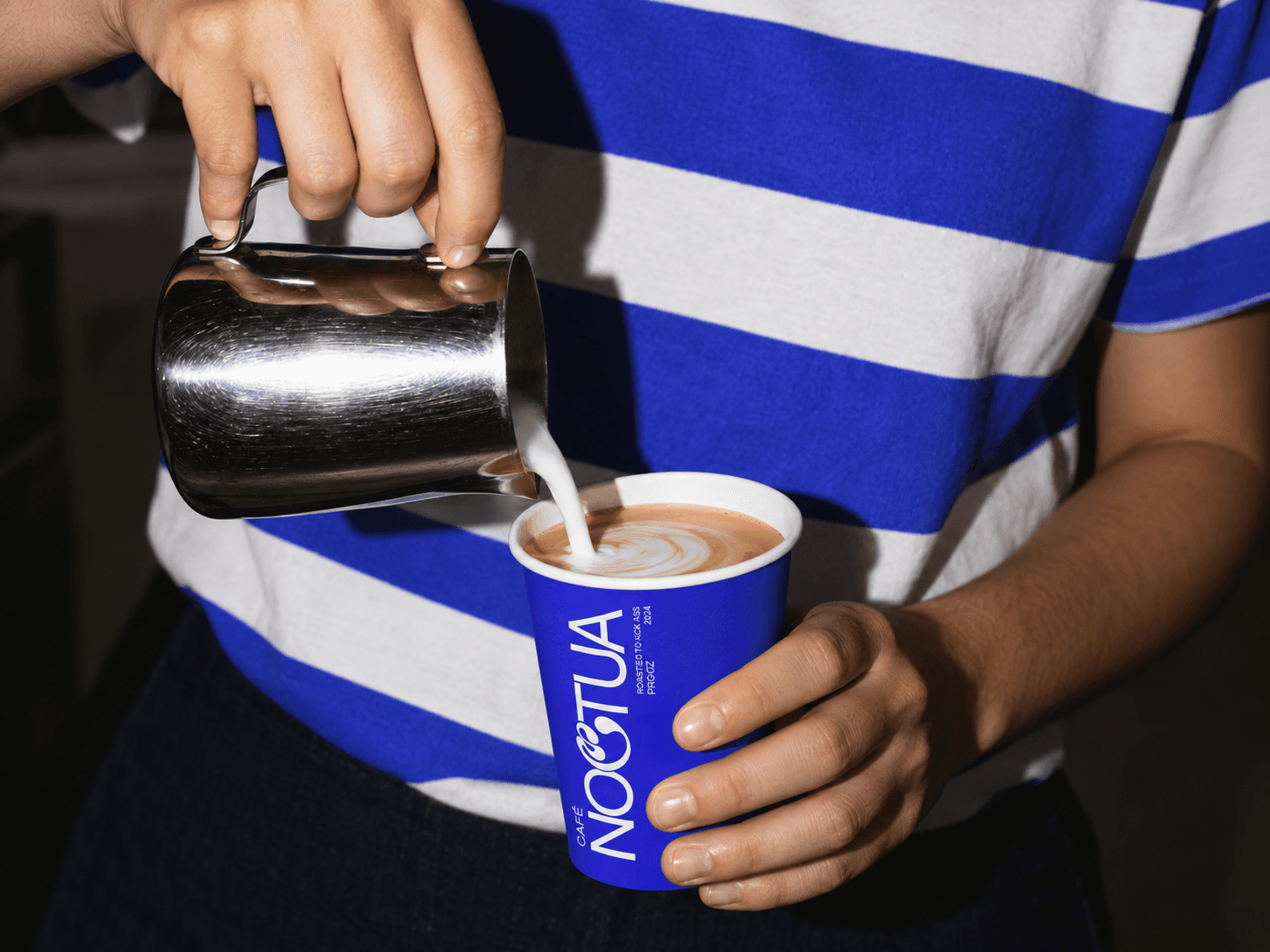 Noctua café identity applied across coffee packaging and the physical space