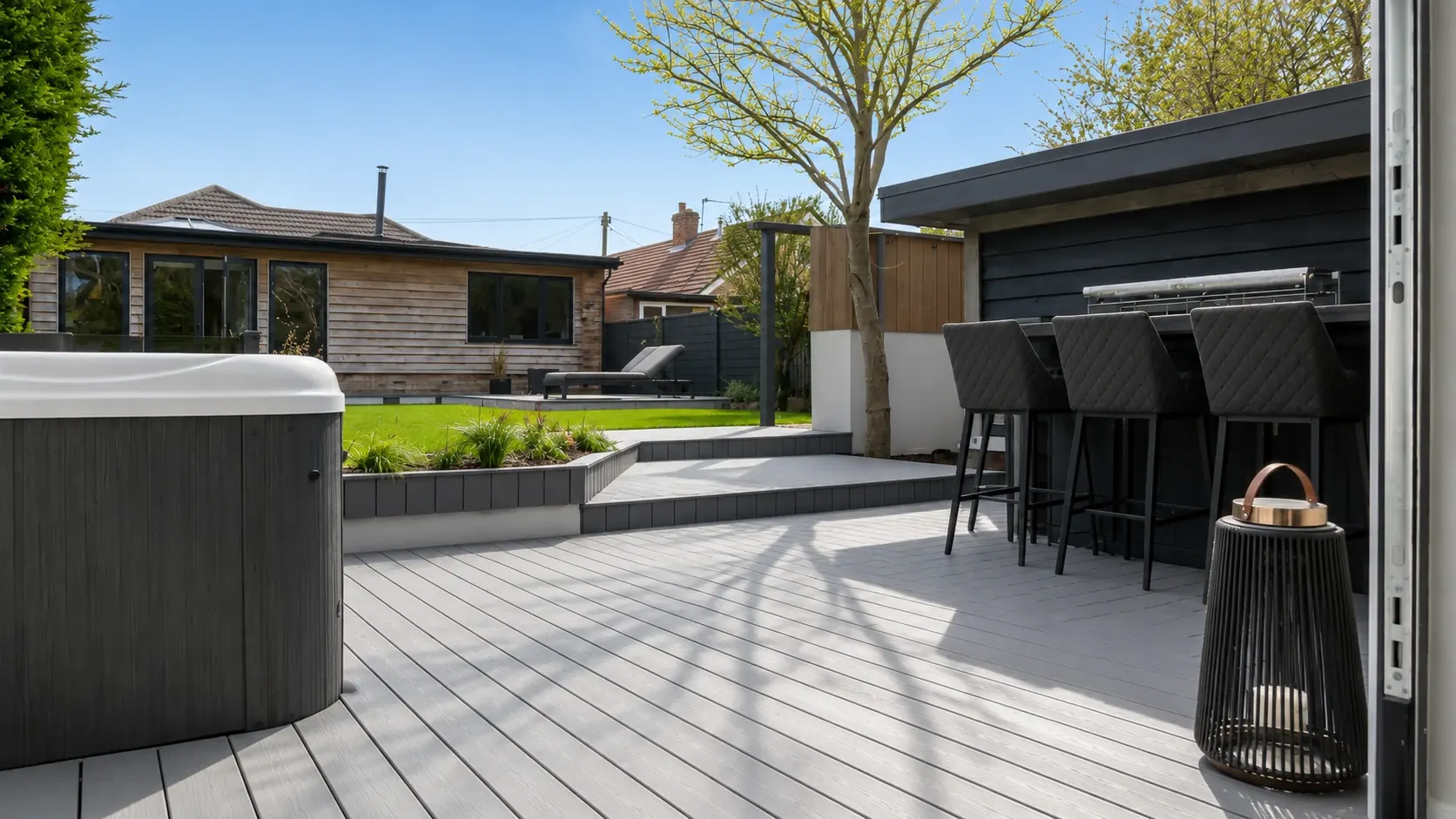 Grey Trex composite deck with outdoor bar and hot tub