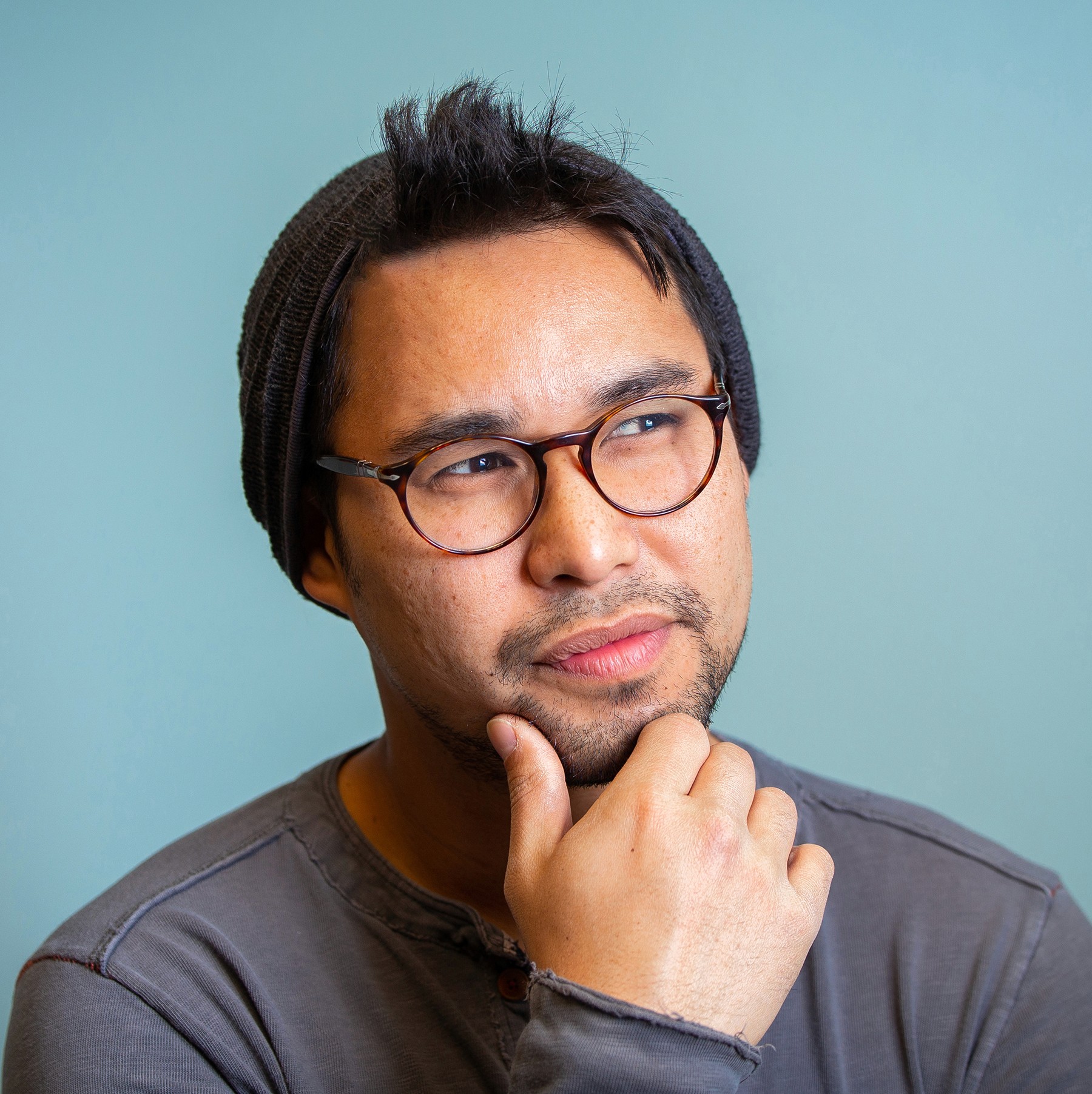 Profile portrait of a man in a grey shirt