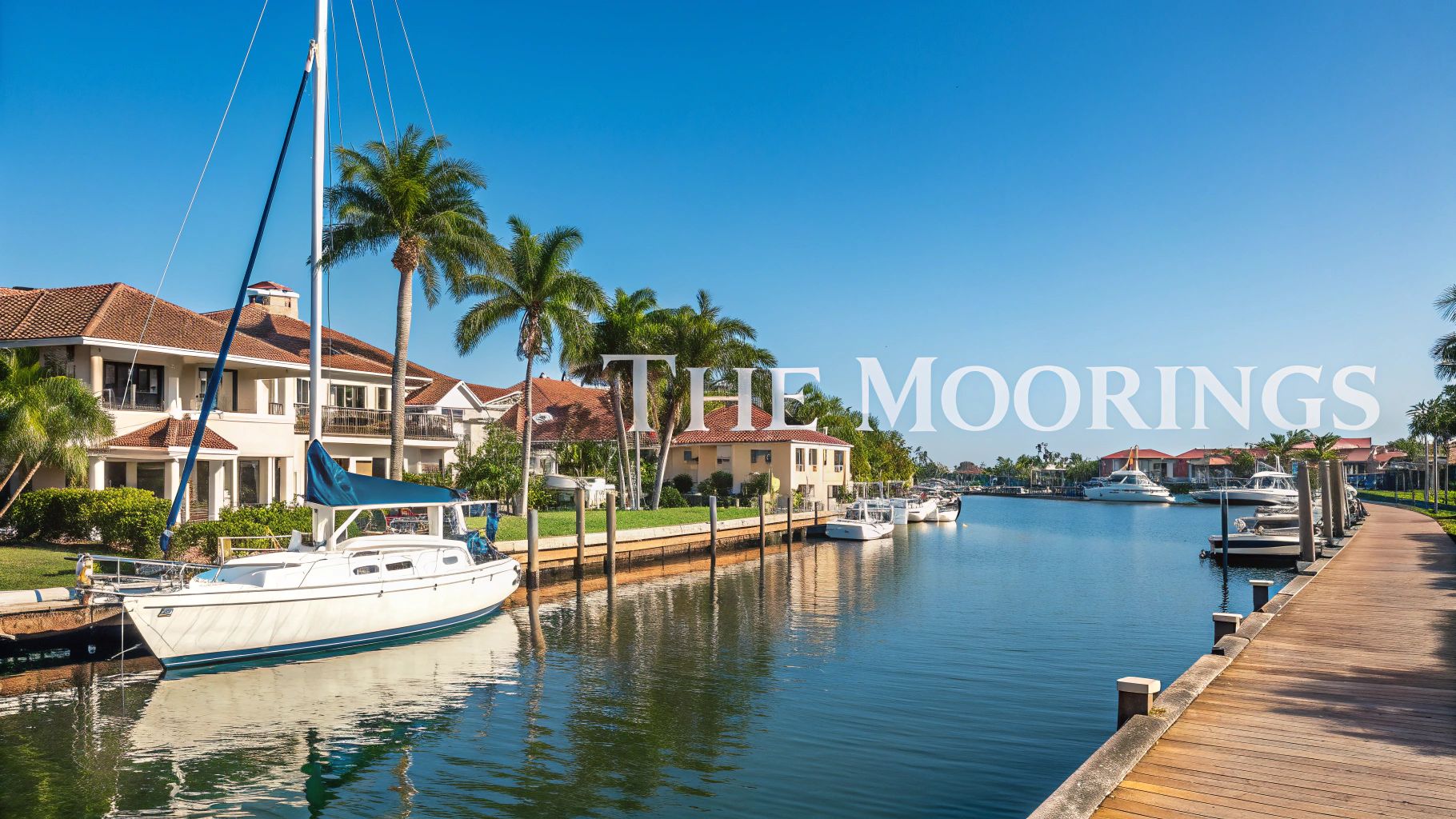 a canal and sailboat with low opacity white text in the foreground reading 'the moorings'