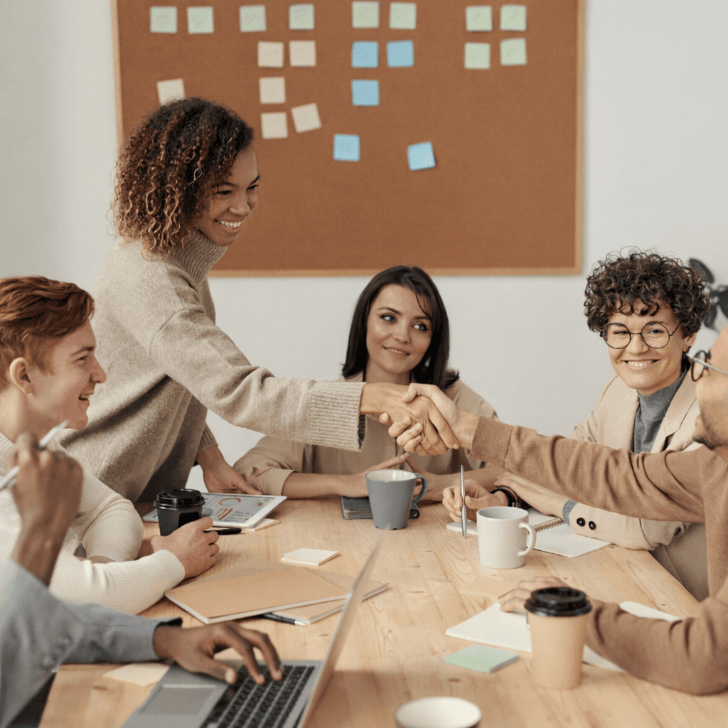 Team meeting in a small business, discussing communications and customer engagement. Focus on business phone systems, AI, and unified inbox strategies.