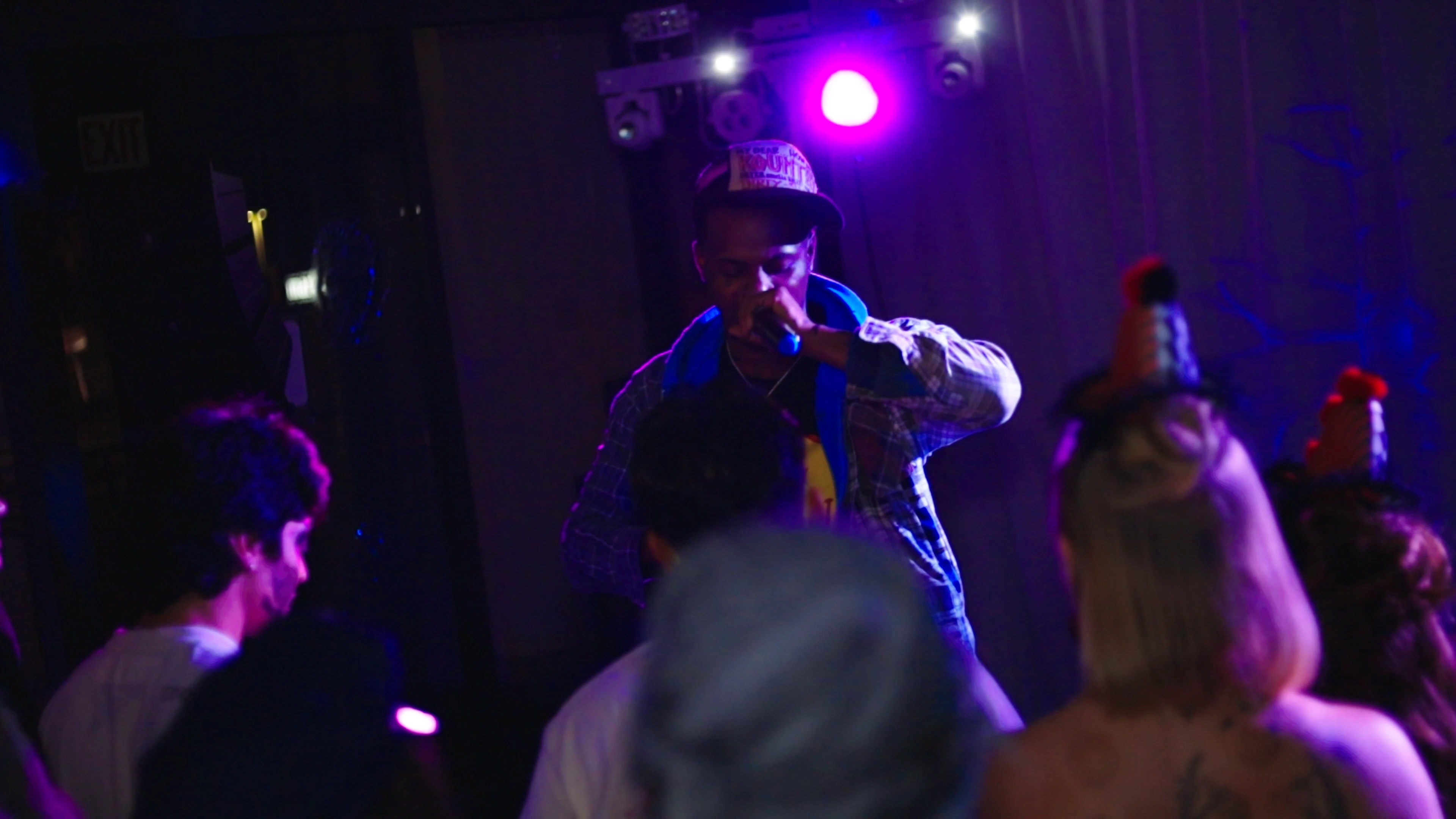 A green butterfly rests on a flower.