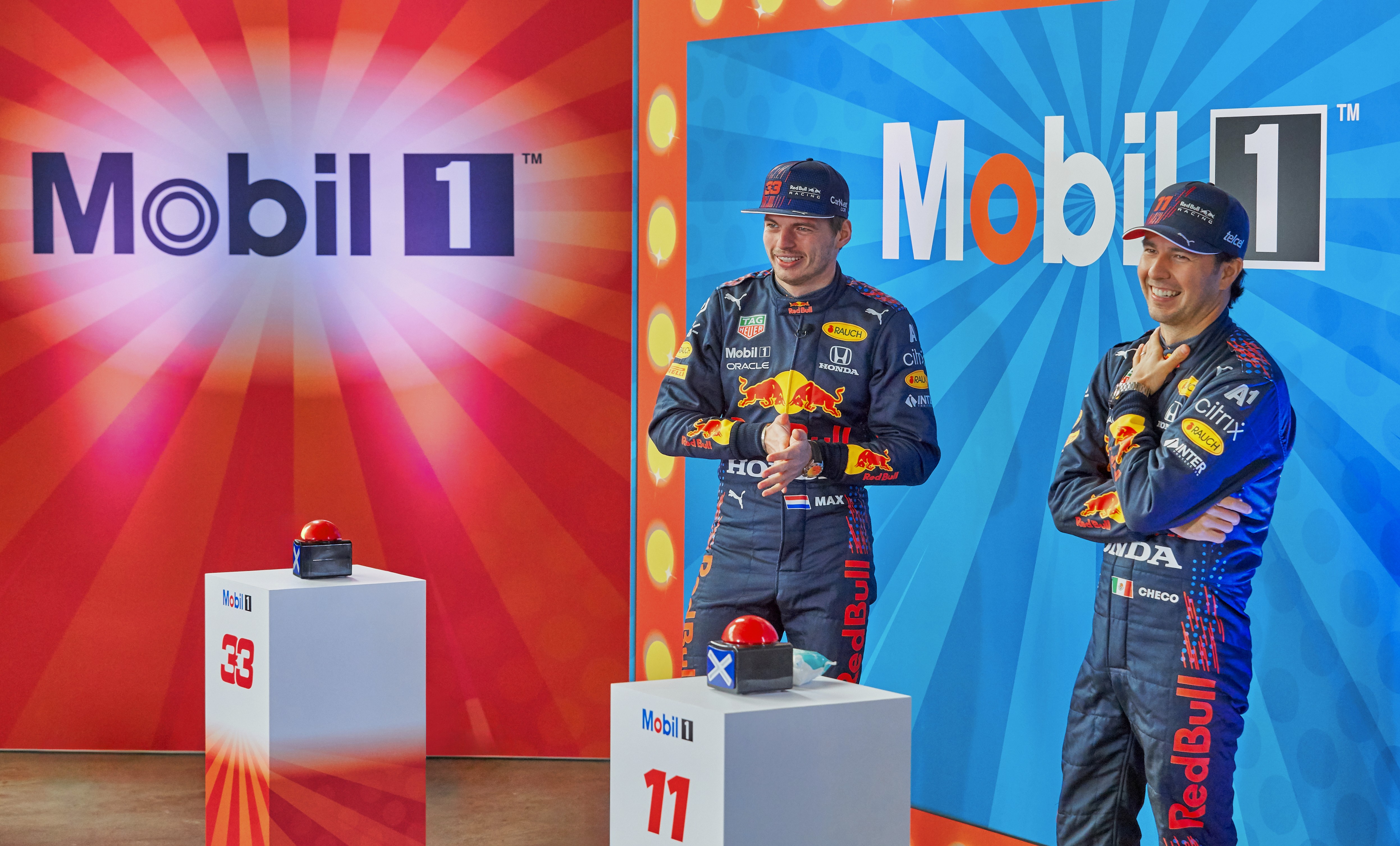  “ExxonMobil PR event with Max Verstappen and Sergio Perez laughing – motorsport event photography.