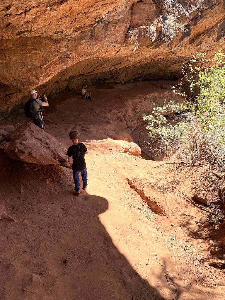 Following the slickrock trail past a sandstone alcove in Zion
