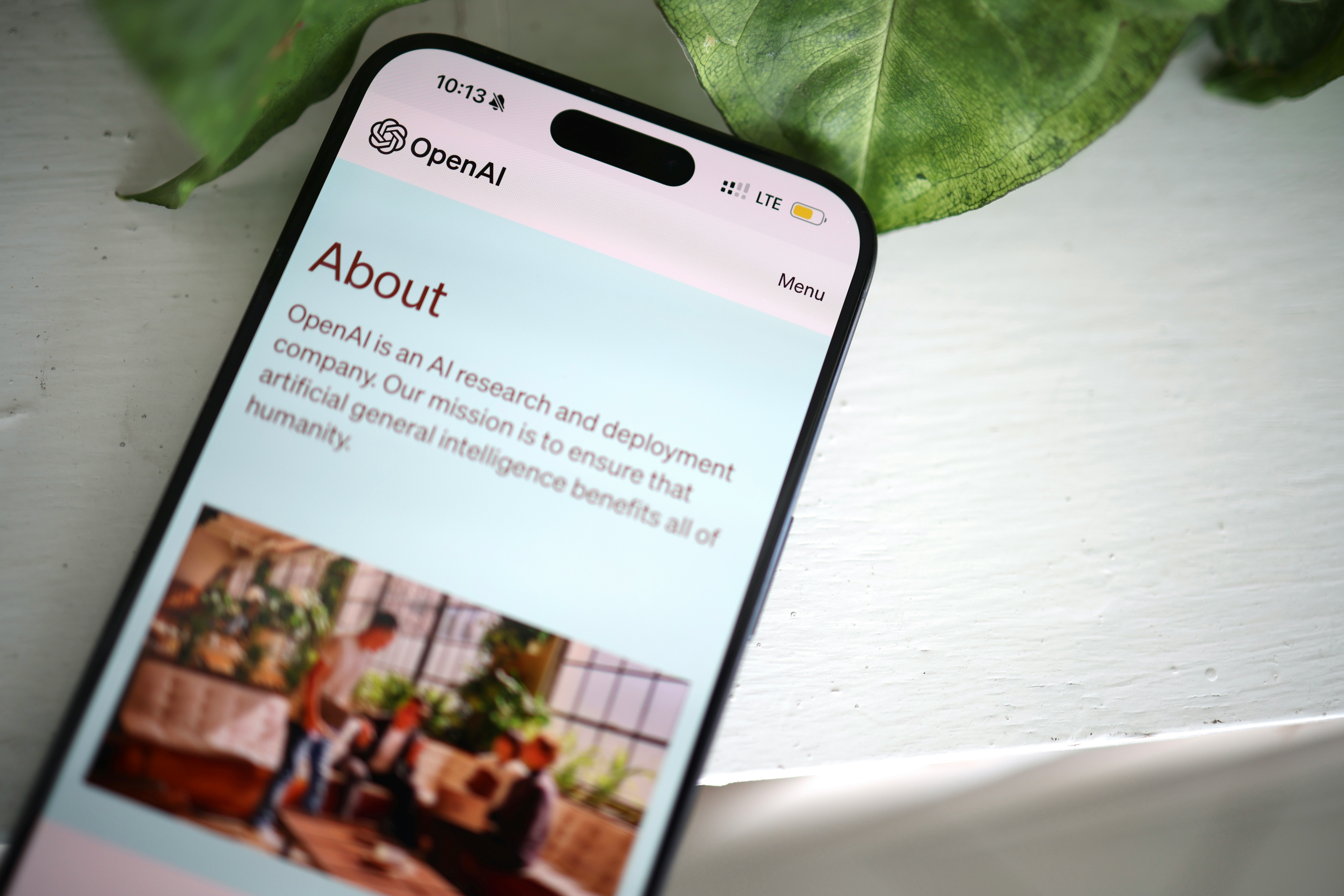 OpenAI About page shown on a smartphone screen, highlighting the company’s mission in artificial intelligence.