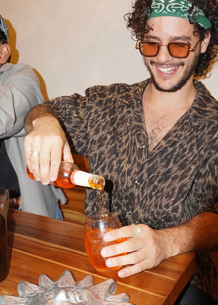 Men drinking Aperol Spritz, wearing silver rings